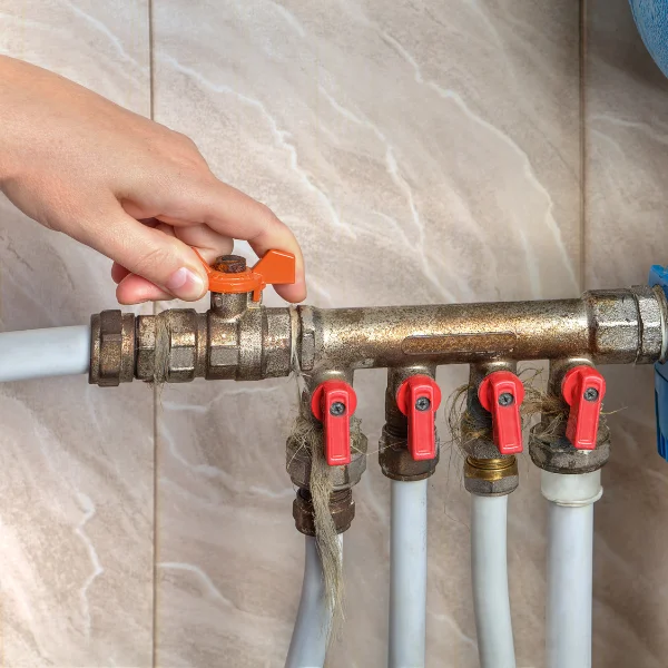 An image of a person turning off the main water valve in an Arizona home.