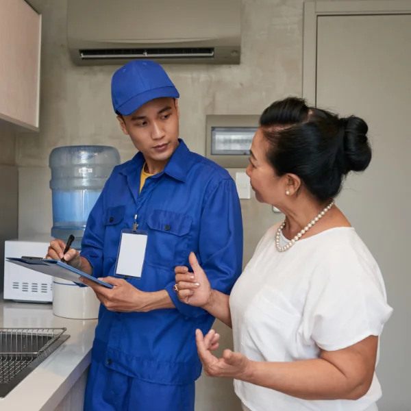 An image showing a person talking with a plumber.