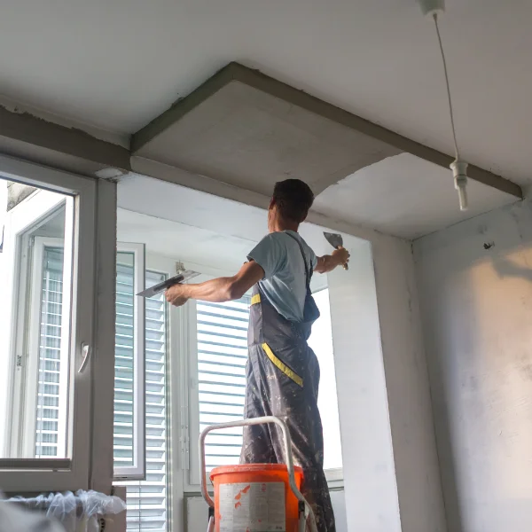 An image showing a contractor renovating a commercial space for a business owner.