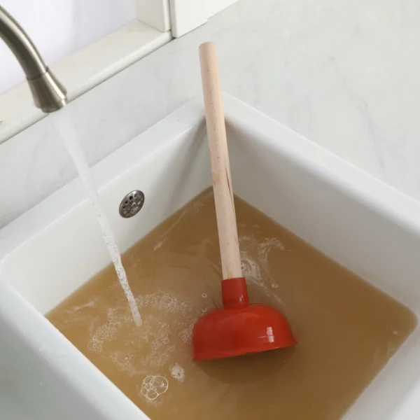 A picture showing a plumber cleaning a drain in Mesa.