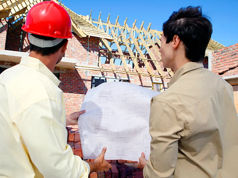 Image showing a contractor talking to a person on a construction site.